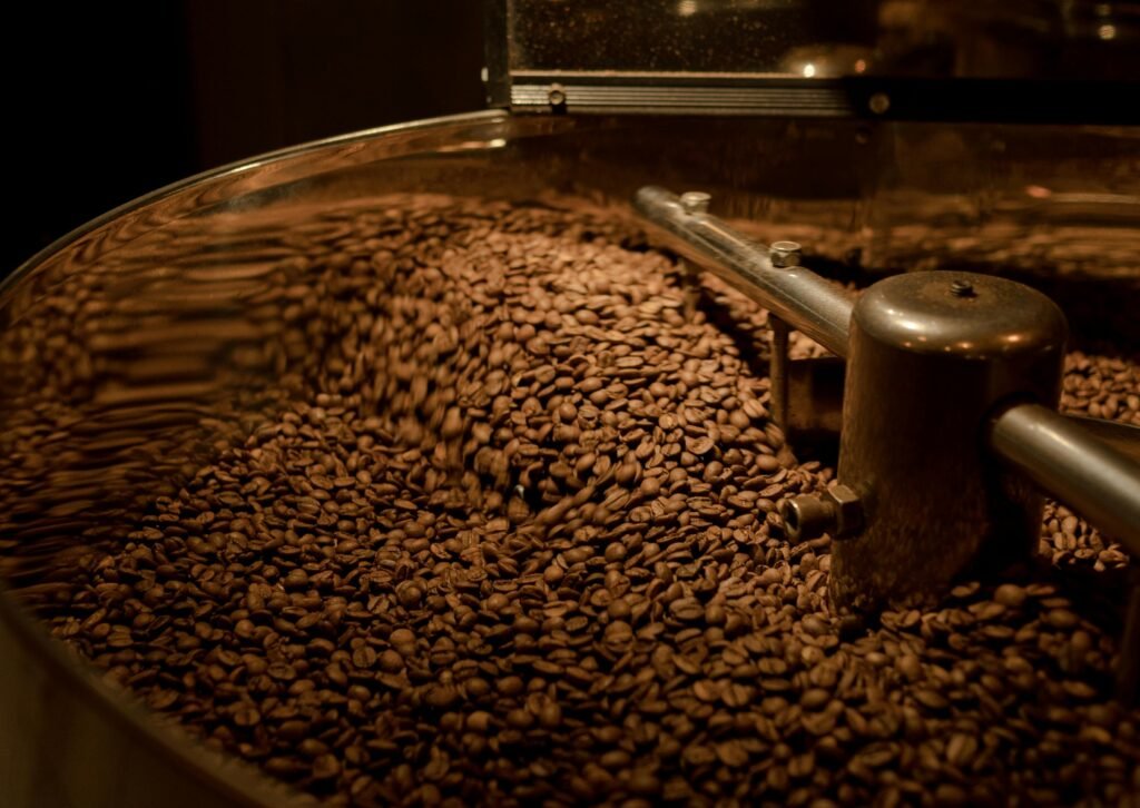 Freshly roasted coffee beans in motion inside a roaster.